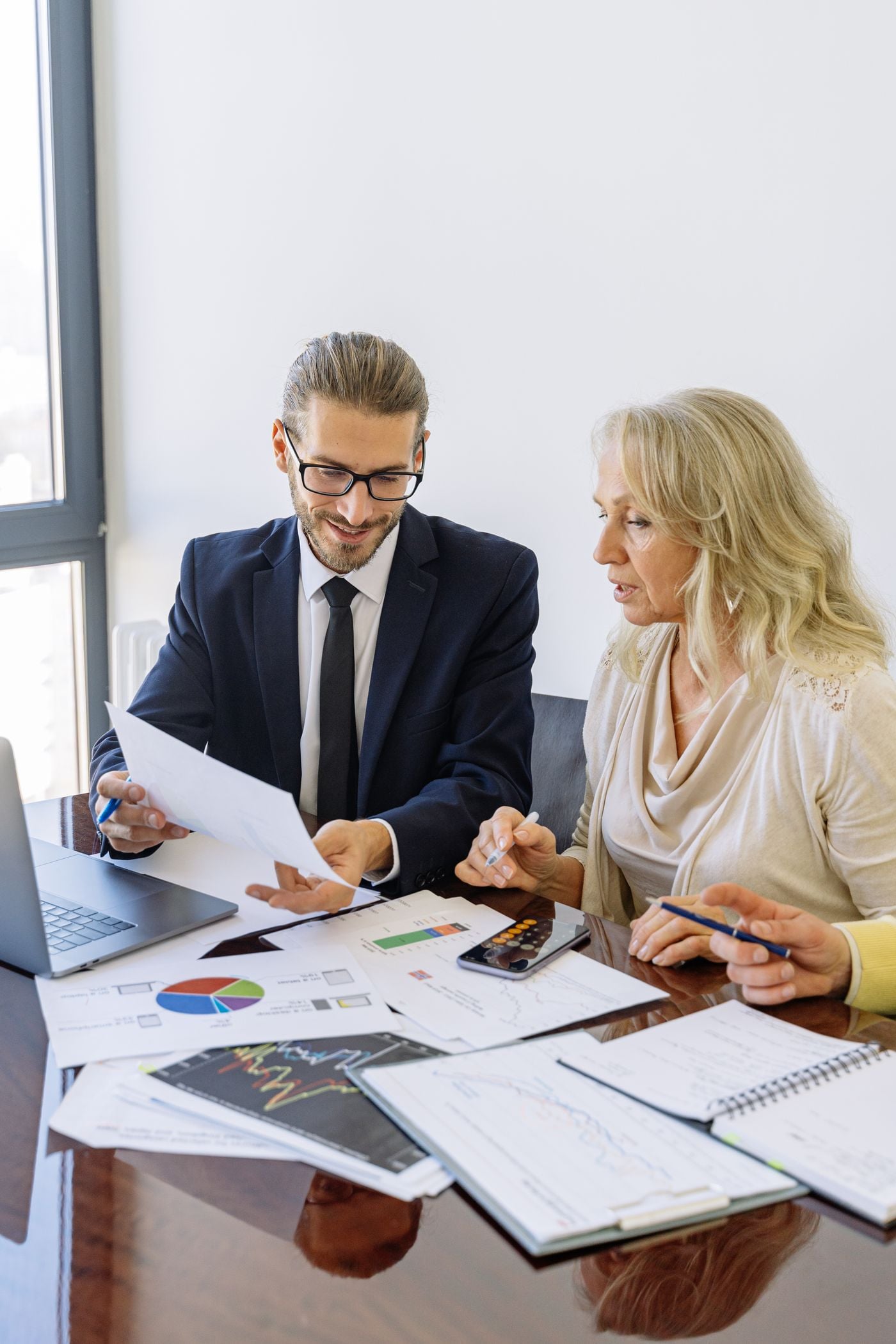 Two professionals reviewing financial documents together
