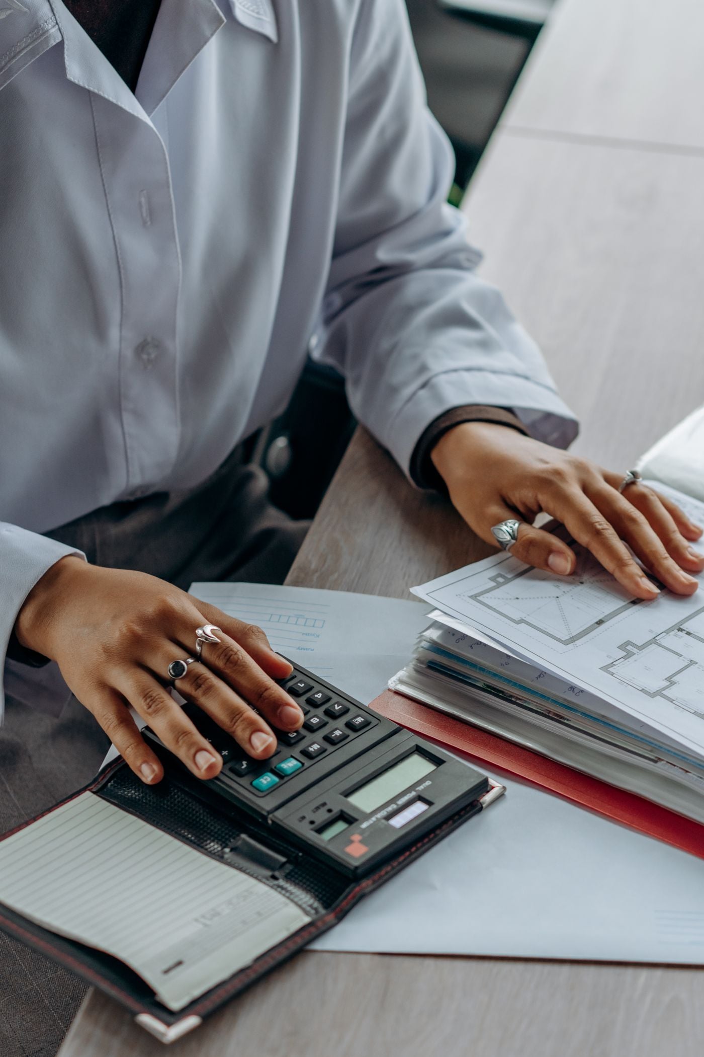 Financial documents being checked alongside a calculator