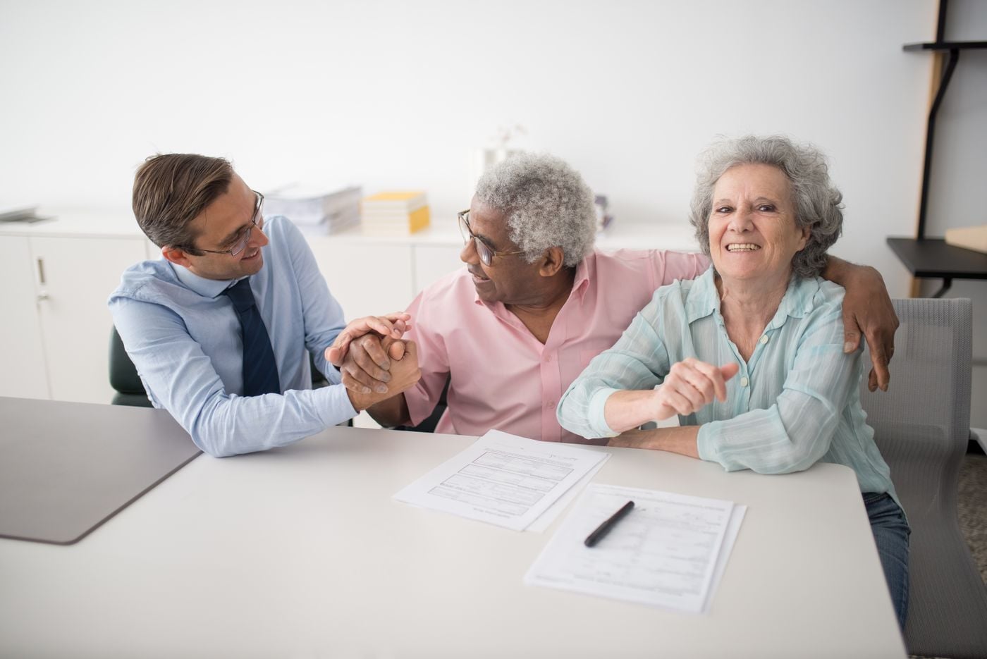 An older couple sharing a warm conversation with their consultant