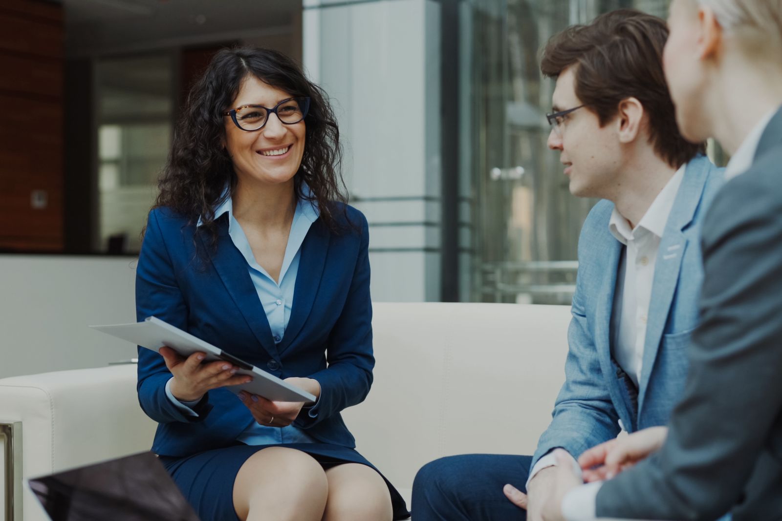 Professionals in conversation in a contemporary office lounge