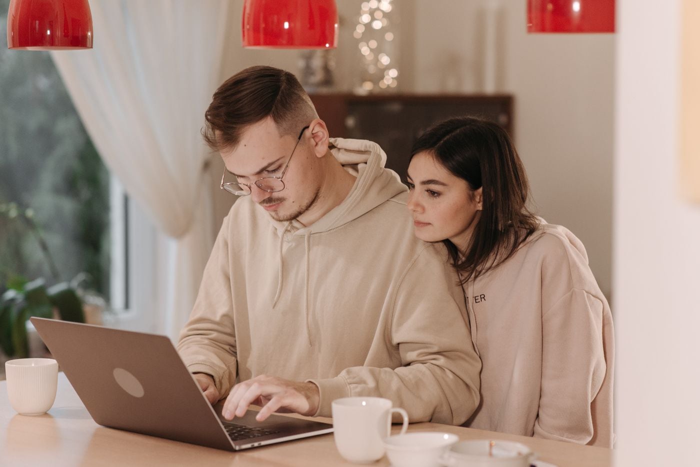 A couple exploring information together on a laptop at home