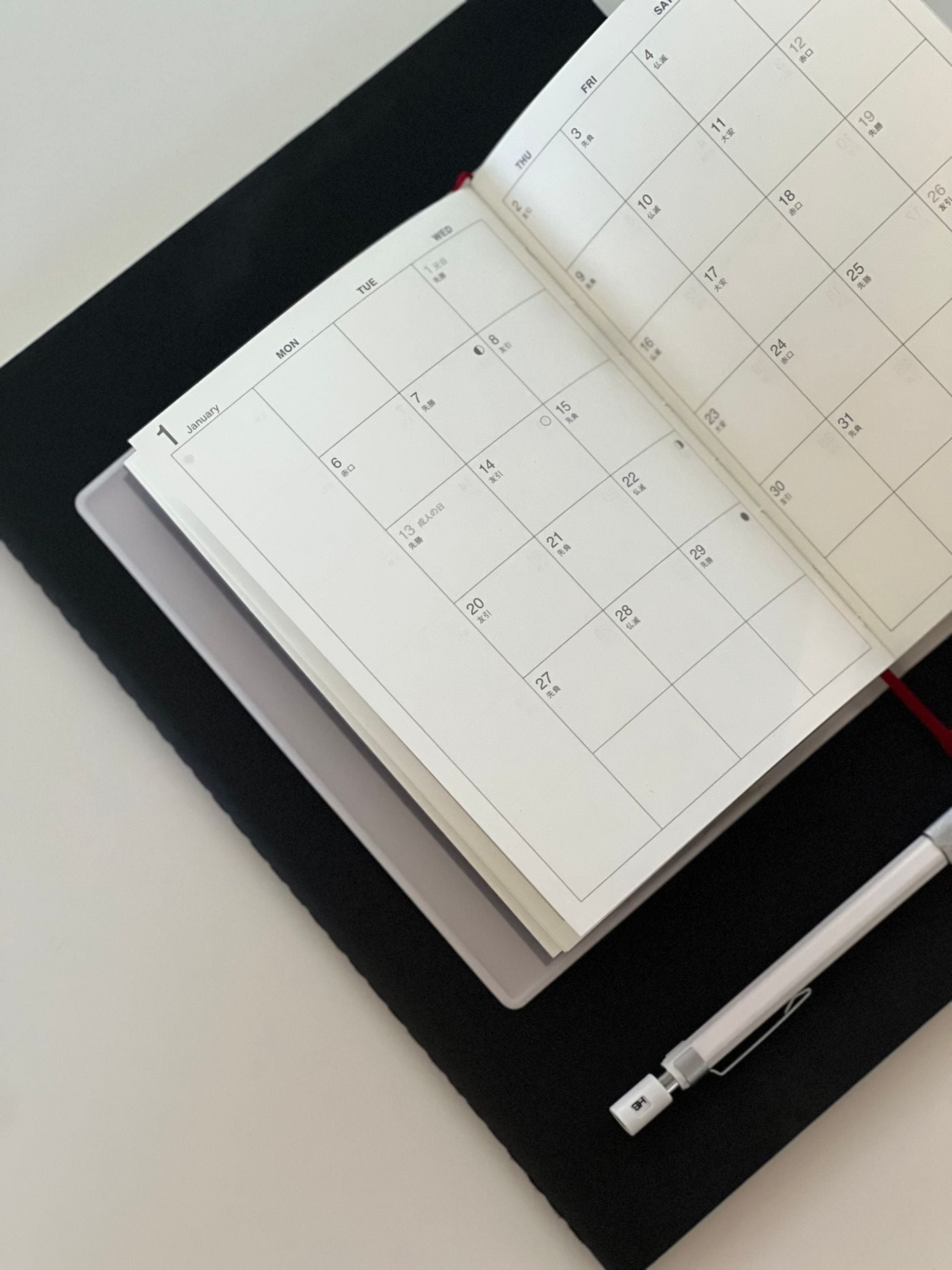 An open planner, pen and tablet ready for a considered working day